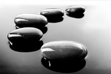 A row of shiny black pebbles in water (Ageshin, Vlad © Ageshin, Vlad; VisaPro.ca. All Rights Reserved.)